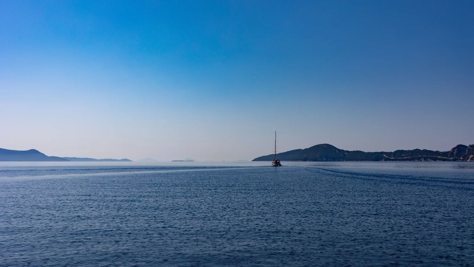 Voilier au large de la Corse pour illustrer un tour complet de l’île